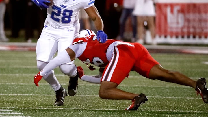 Middle Tennessee running back Rickey Hunt Jr. (28) runs the ball as Western Kentucky defensive back Jai Eugene Jr. (26) makes the stop during an NCAA College Football game at Western Kentucky on Saturday, Nov. 15, 2025.