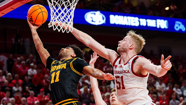 Mar 8, 2026; Lincoln, Nebraska, USA; Iowa Hawkeyes guard Kael Combs (11) shoots the ball against Nebraska Cornhuskers forward Pryce Sandfort (21) and forward Rienk Mast (51) during the second half at Pinnacle Bank Arena. Mandatory Credit: Dylan Widger-Imagn Images Mar 8, 2026; Lincoln, Nebraska, USA; Iowa Hawkeyes guard Kael Combs (11) shoots the ball against Nebraska Cornhuskers forward Pryce Sandfort (21) and forward Rienk Mast (51) during the second half at Pinnacle Bank Arena. Mandatory Credit: Dylan Widger-Imagn Images