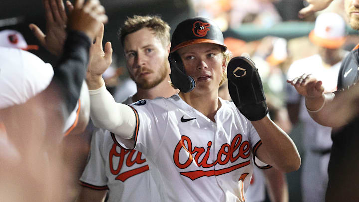 Mar 14, 2025; Sarasota, Florida, USA;  Baltimore Orioles second base Jackson Holliday (7) is congratulated  in the dugout after he scored a run during the fifth inning against the Minnesota Twins at Ed Smith Stadium.