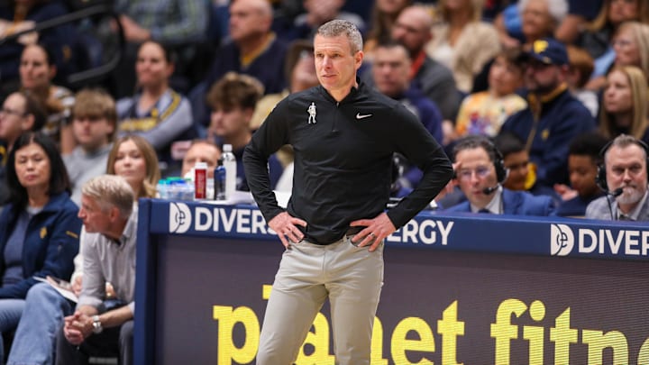 Nov 30, 2025; Morgantown, West Virginia, USA; West Virginia Mountaineers head coach Ross Hodge watches along the sidelines during the first half against the Mercyhurst Lakers at Hope Coliseum. Mandatory Credit: Ben Queen-Imagn Images Nov 30, 2025; Morgantown, West Virginia, USA; West Virginia Mountaineers head coach Ross Hodge watches along the sidelines during the first half against the Mercyhurst Lakers at Hope Coliseum. Mandatory Credit: Ben Queen-Imagn Images