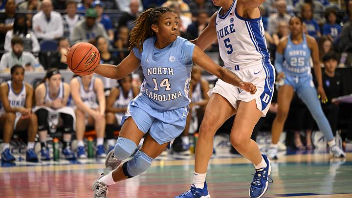 Mar 3, 2023; Greensboro, NC, USA; North Carolina Tar Heels guard Kayla McPherson (14) dribbles against Duke Blue Devils forward Taya Corosdale (5) during the first half at Greensboro Coliseum. Mandatory Credit: William Howard-USA TODAY Sports