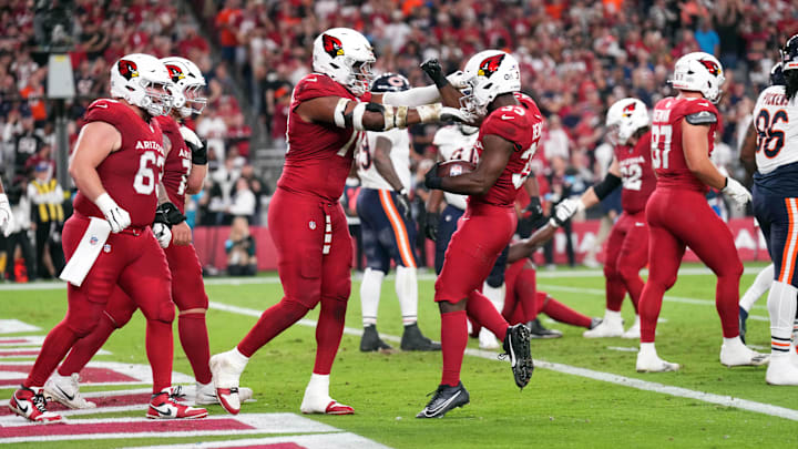 Nov 3, 2024; Glendale, Arizona, USA; Arizona Cardinals running back Trey Benson (33) celebrates a touchdown against the Chicago Bears during the first half at State Farm Stadium. Mandatory Credit: Joe Camporeale-Imagn Images