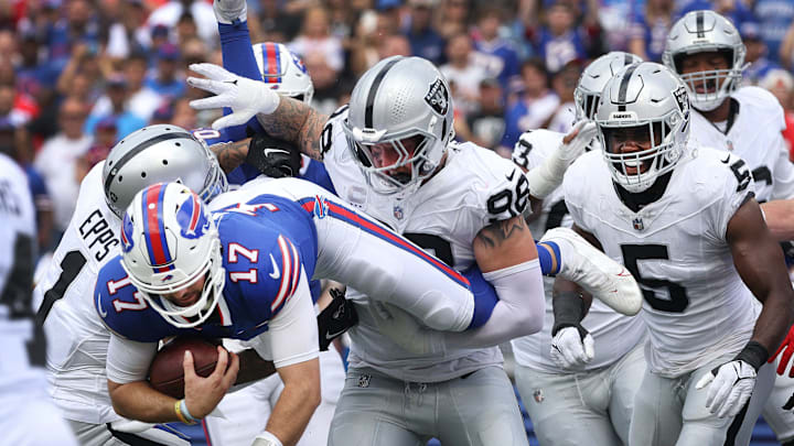 Bills quarterback Josh Allen tries to jump over the Raiders defensive line near the end zone.