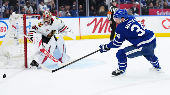 Dec 16, 2025; Toronto, Ontario, CAN; Toronto Maple Leafs center Auston Matthews (34) tries to play the puck in front of Chicago Blackhawks goaltender Spencer Knight (30) during the first period at Scotiabank Arena. Mandatory Credit: Nick Turchiaro-Imagn Images
