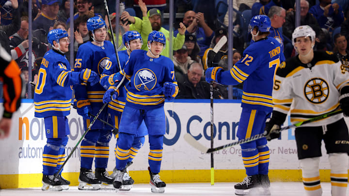 Jan 28, 2025; Buffalo, New York, USA;  Buffalo Sabres right wing JJ Peterka (77) celebrates his goal with teammates during the third period against the Boston Bruins at KeyBank Center. Mandatory Credit: Timothy T. Ludwig-Imagn Images