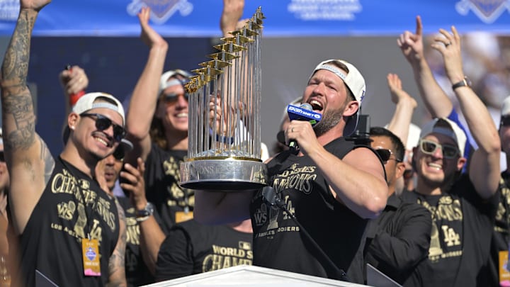 Nov 1, 2024; Los Angeles, CA, USA; Starting pitcher Clayton Kershaw (22) lifts the World Series Championship Trophy during the team celebration at Dodger Stadium.