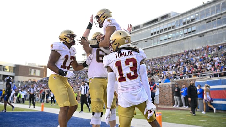 Nov 16, 2024; Dallas, Texas, USA; Boston College Eagles quarterback Grayson James (14) celebrates with his teammates after he scores a touchdown against the SMU Mustangs during the second half at Gerald J. Ford Stadium. Mandatory Credit: Jerome Miron-Imagn Images