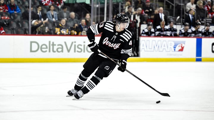 Apr 11, 2025; Newark, New Jersey, USA; New Jersey Devils defenseman Luke Hughes (43) skates with the puck during the third period against the Pittsburgh Penguins at Prudential Center. Mandatory Credit: John Jones-Imagn Images