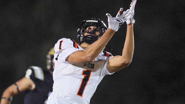 Oviedo Jordan Donahoo (1) tries to catch the pass under pressure from Oviedo Bruce Slivinski (5) during the 2025 FHSAA Football 6A quarter final at Citizens Field in Gainesville, FL on Thursday, November 13, 2025. [Alan Youngblood/Gainesville Sun]