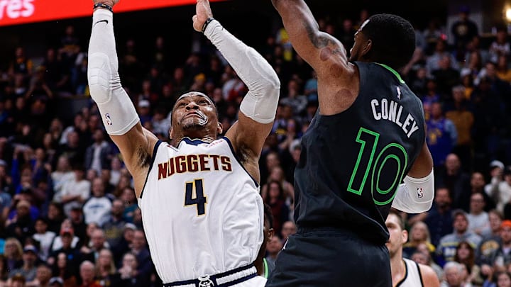 Apr 1, 2025; Denver, Colorado, USA; Denver Nuggets guard Russell Westbrook (4) attempts a shot against Minnesota Timberwolves guard Mike Conley (10) in overtime at Ball Arena. Mandatory Credit: Isaiah J. Downing-Imagn Images