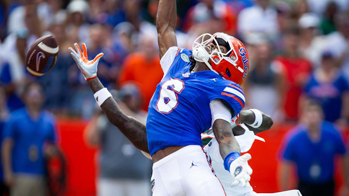 Miami Hurricanes defensive back Damari Brown (6) breaks up a pass intended for Florida Gators wide receiver Elijhah Badger (6) during the season opener at Ben Hill Griffin Stadium in Gainesville, FL on Saturday, August 31, 2024 against the University of Miami Hurricanes in the first half. [Doug Engle/Gainesville Sun]