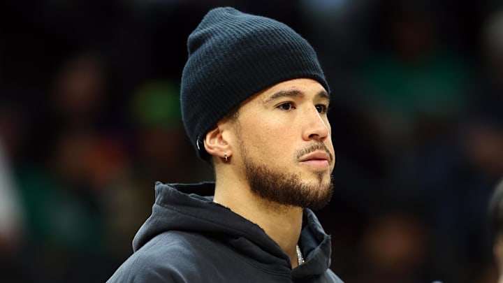 Feb 24, 2026; Phoenix, Arizona, USA; Phoenix Suns injured guard Devin Booker against the Boston Celtics in the second half at Mortgage Matchup Center. Mandatory Credit: Mark J. Rebilas-Imagn Images