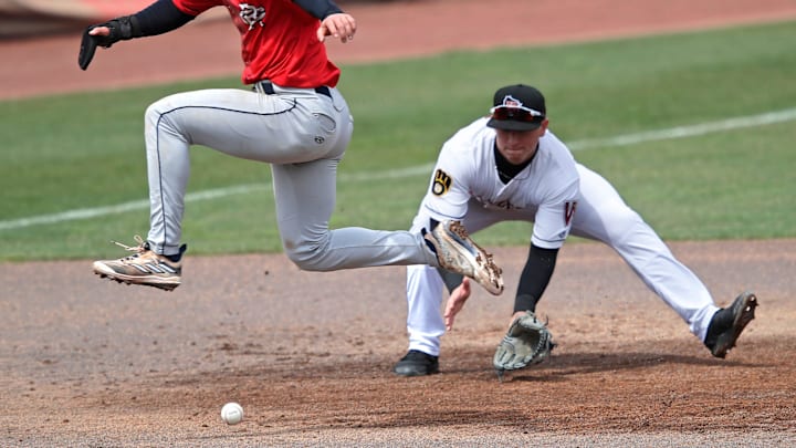 Cedar Rapids Kernels' Luke Keaschall (44) hurdles the ball as Wisconsin Timber Rattlers' Mike Boeve (19) fields it during their baseball game Wednesday, April 17, 2024, at Neuroscience Group Field at Fox Cities Stadium in Grand Chute, Wisconsin.