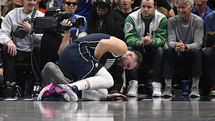 Oct 24, 2024; Dallas, Texas, USA; Dallas Mavericks guard Luka Doncic (77) falls to the floor with a possible lower body injury during the second quarter against the San Antonio Spurs at the American Airlines Center. Mandatory Credit: Jerome Miron-Imagn Images