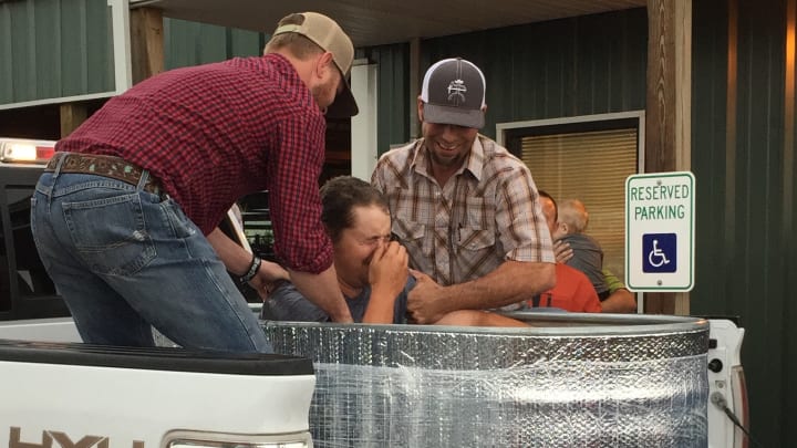WOSC College rodeo student being baptized at the practice arena during Cross Brand nights WOSC College rodeo student being baptized at the practice arena during Cross Brand nights