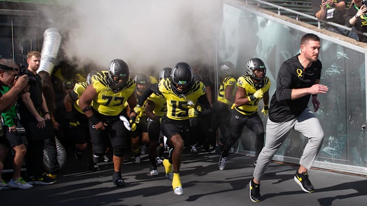 Oregon coach Dan Lanning leads his team onto the field veer their game against Illinois at Autzen Stadium in Eugene Saturday, Oct 26, 2024.