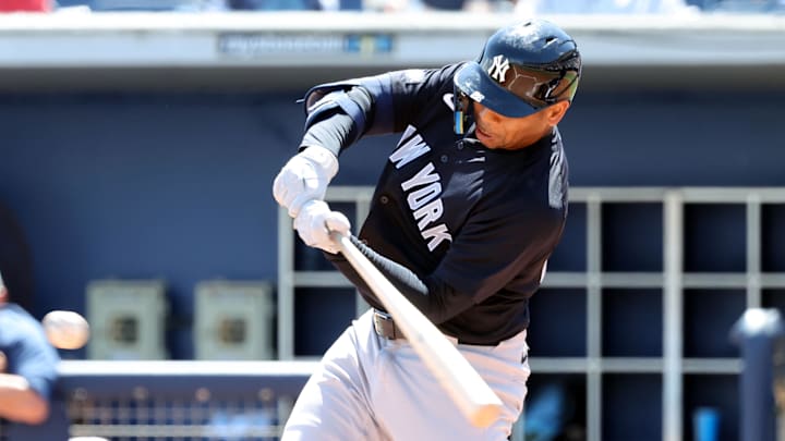 Mar 15, 2025; Port Charlotte, Florida, USA;  New York Yankees designated hitter Dominic Smith (22) hits a RBI during the third inning against the Tampa Bay Rays at Charlotte Sports Park.