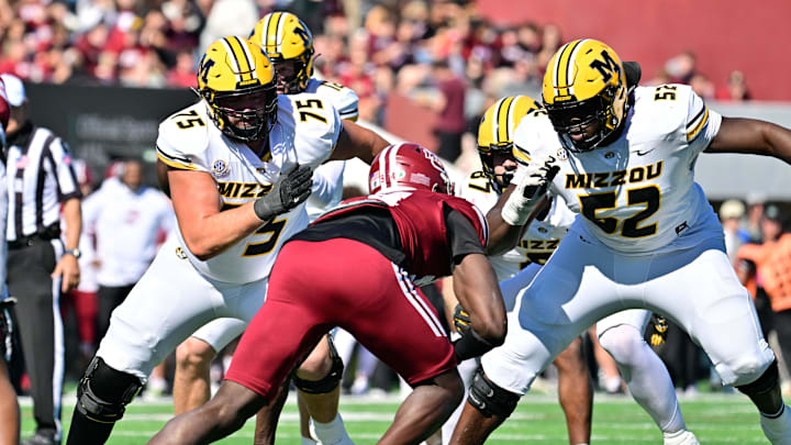 Oct 12, 2024; Amherst, Massachusetts, USA; Missouri Tigers offensive lineman Mitchell Walters (75) and offensive lineman Marcus Bryant (52)  blocking Massachusetts Minutemen defensive end Kofi Asare (94) during the first half at Warren McGuirk Alumni Stadium. Mandatory Credit: Eric Canha-Imagn Images