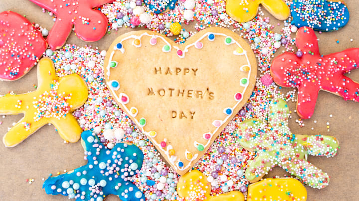 Cookie reading "Happy Mother's Day" surrounded by colorful gingerbread men