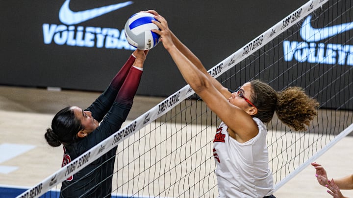 Nebraska's Rebekah Allick fights to get the ball over the net with a Stanford defender. 