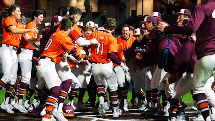 Ethan Ball celebrating with teammates at home plate after hitting a walk-off home run.