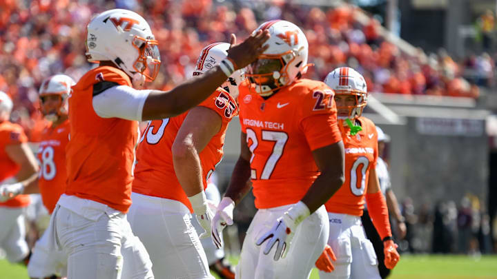 Oct 4, 2025; Blacksburg, Virginia, USA; 
Virginia Tech Hokies running back Marcellous Hawkins (27) celebrates with quarterback Kyron Drones (1) after scoring a touchdown against the Wake Forest Demon Deacons during the first quarter at Lane Stadium. Mandatory Credit: Brian Bishop-Imagn Images