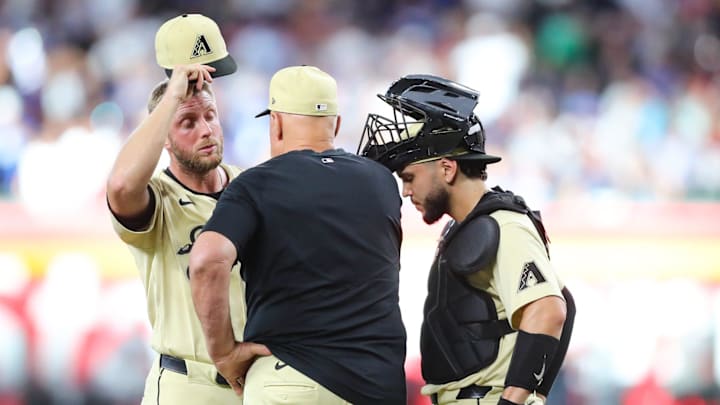 Arizona Diamondbacks pitcher Merrill Kelly (29) is talked to on the mound by pitching coach Brent Strom after giving up back-to-back-to-back home runs at Chase Field on Aug. 31, 2024, in Phoenix. Arizona Diamondbacks pitcher Merrill Kelly (29) is talked to on the mound by pitching coach Brent Strom after giving up back-to-back-to-back home runs at Chase Field on Aug. 31, 2024, in Phoenix.