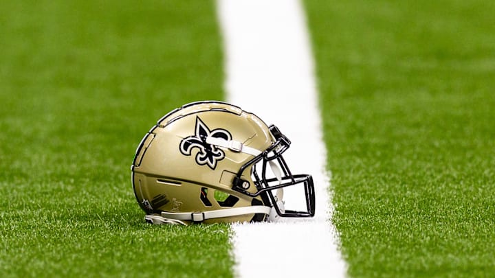 Aug 25, 2024; New Orleans, Louisiana, USA;  New Orleans Saints helmet on the turf during warmups before the game against the Tennessee Titans at Caesars Superdome. Mandatory Credit: Stephen Lew-Imagn Images