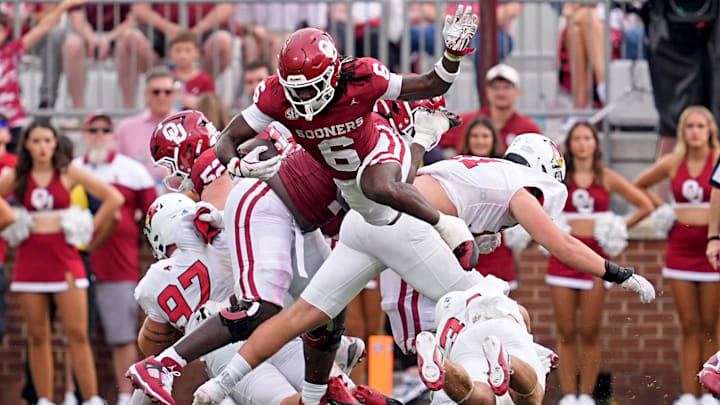 Oklahoma running back Tory Blaylock leaps over would-be tacklers against Illinois State. Oklahoma running back Tory Blaylock leaps over would-be tacklers against Illinois State.