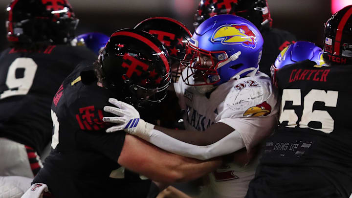 Oct 11, 2025; Lubbock, Texas, USA;  Texas Tech Red Raiders offensive center Sheridan Wilson blocks Kansas Jayhawks defensive tackle Tommy Dunn Jr. (92) in the second half at Jones AT&T Stadium. Mandatory Credit: Michael C. Johnson-Imagn Images