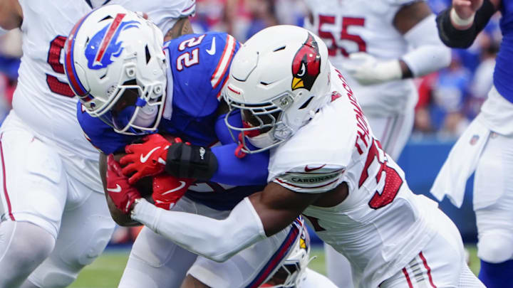 Sep 8, 2024; Orchard Park, New York, USA; Arizona Cardinals safety Jalen Thompson (34) tackles Buffalo Bills running back James Cook (4) during the second half at Highmark Stadium. Mandatory Credit: Gregory Fisher-Imagn Images