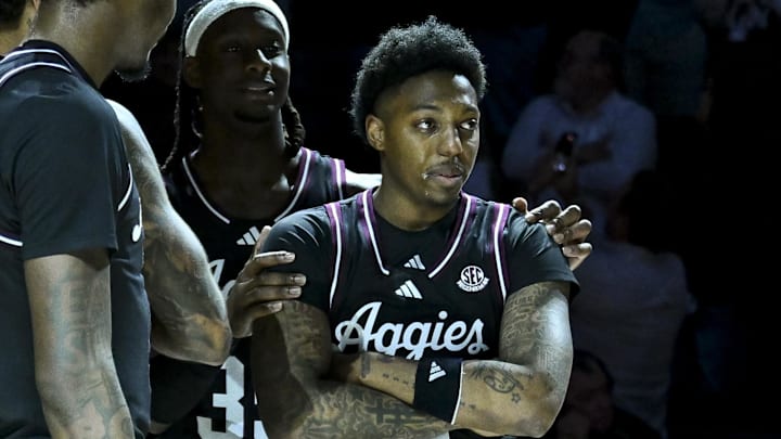 Mar 4, 2025; College Station, Texas, USA; Texas A&M Aggies guard Wade Taylor IV, right,  reacts during the post game celebration honoring him at Reed Arena. Mandatory Credit: Maria Lysaker-Imagn Images 