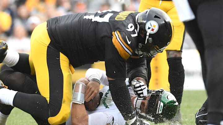 Oct 2, 2022; Pittsburgh, Pennsylvania, USA;  Pittsburgh Steelers defensive tackle Cameron Heyward (97) tackles New York Jets quarterback Zach Wilson (2) during the fourth quarter at Acrisure Stadium. Mandatory Credit: Philip G. Pavely-Imagn Images