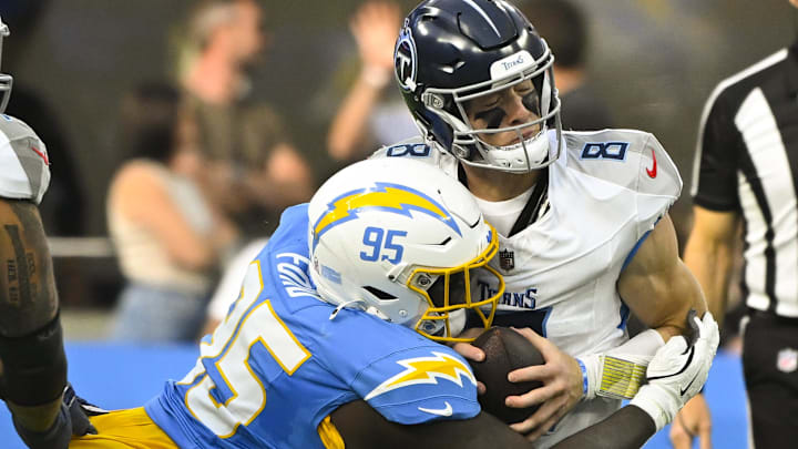 Los Angeles Chargers defensive tackle Poona Ford (95) sacks Tennessee Titans quarterback Will Levis (8) during the second quarter at SoFi Stadium last season.