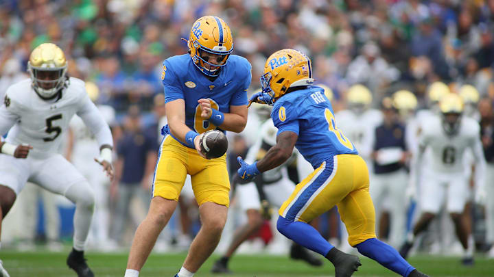 Pittsburgh Panthers quarterback Mason Heintschel (6) hands the ball off to running back Desmond Reid (0) during the first half against the Notre Dame Fighting Irish at Acrisure Stadium in Pittsburgh, PA on November 15, 2025.