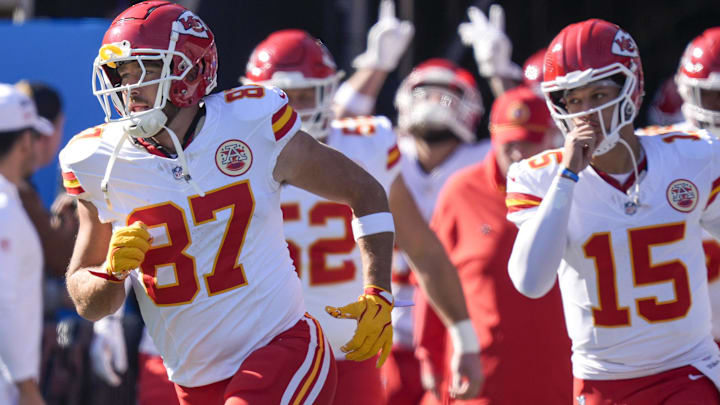 Nov 24, 2024; Charlotte, North Carolina, USA; Kansas City Chiefs tight end Travis Kelce (87) and quarterback Patrick Mahomes (15) lead their team onto the field against the Carolina Panthers during the first quarter at Bank of America Stadium. Mandatory Credit: Jim Dedmon-Imagn Images Nov 24, 2024; Charlotte, North Carolina, USA; Kansas City Chiefs tight end Travis Kelce (87) and quarterback Patrick Mahomes (15) lead their team onto the field against the Carolina Panthers during the first quarter at Bank of America Stadium. Mandatory Credit: Jim Dedmon-Imagn Images
