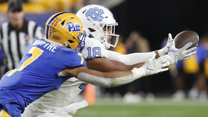 Sep 23, 2023; Pittsburgh, Pennsylvania, USA; North Carolina Tar Heels tight end Bryson Nesbit (18) makes a catch against Pittsburgh Panthers defensive back Javon McIntyre (7) during the third quarter at Acrisure Stadium. Mandatory Credit: Charles LeClaire-Imagn Images
