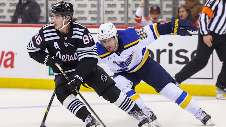 New Jersey Devils center Jack Hughes (86) skates with St. Louis Blues left wing Brandon Saad (20). Mandatory Credit: Ed Mulholland-Imagn Images