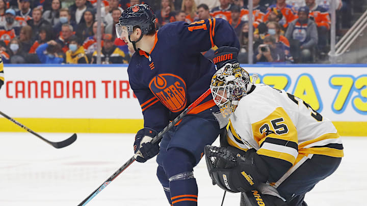 Dec 1, 2021; Edmonton, Alberta, CAN; Edmonton Oilers forward Zach Hyman (18) tries to screen Pittsburgh Penguins goaltender Tristan Jarry (35) during the first period at Rogers Place. Mandatory Credit: Perry Nelson-Imagn Images