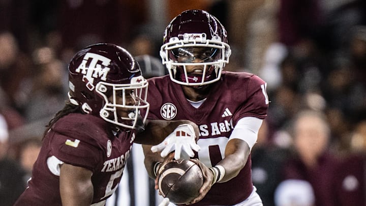 Nov 30, 2024; College Station, Texas, USA; Texas A&M Aggies quarterback Marcel Reed (10) hands the ball off to running back Amari Daniels (5) in the first quarter of the Lone Star Showdown against the Texas Longhorns at Kyle Field. Mandatory Credit: Sara Diggins/USA TODAY Network via Imagn Images