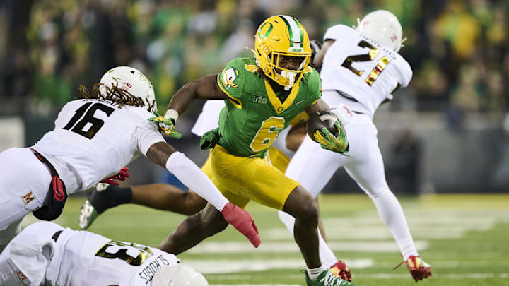 Nov 9, 2024; Eugene, Oregon, USA; Oregon Ducks running back Noah Whittington (6) breaks away from Maryland Terrapins linebacker Daniel Wingate (16) during the second half for a first down at Autzen Stadium. Mandatory Credit: Troy Wayrynen-Imagn Images