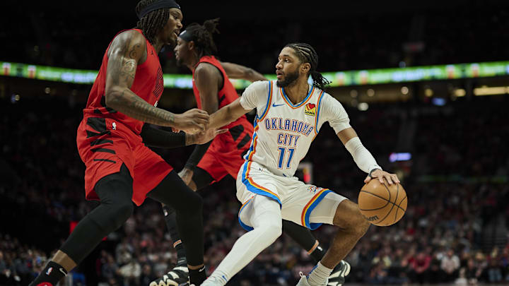 Jan 26, 2025; Portland, Oregon, USA; Oklahoma City Thunder guard Isaiah Joe (11) dribbles the ball during the second half against Portland Trail Blazers center Robert Williams III (35) at Moda Center. Mandatory Credit: Troy Wayrynen-Imagn Images Jan 26, 2025; Portland, Oregon, USA; Oklahoma City Thunder guard Isaiah Joe (11) dribbles the ball during the second half against Portland Trail Blazers center Robert Williams III (35) at Moda Center. Mandatory Credit: Troy Wayrynen-Imagn Images