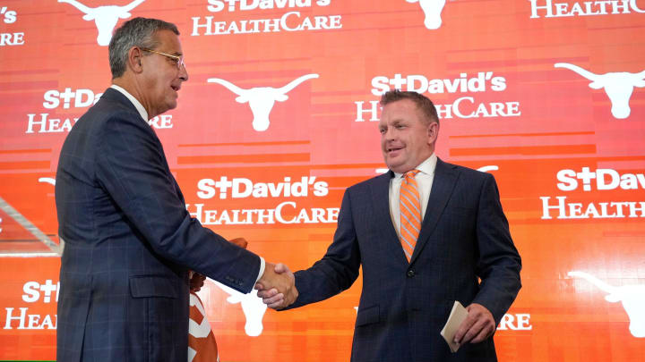 University of Texas baseball coach Jim Schlossnagle, right, is introduced by Athletic Director Chris Del Conte at his introductory news conference at the Frank Denius Family University Hall of Fame Wednesday June 26, 2024. University of Texas baseball coach Jim Schlossnagle, right, is introduced by Athletic Director Chris Del Conte at his introductory news conference at the Frank Denius Family University Hall of Fame Wednesday June 26, 2024.