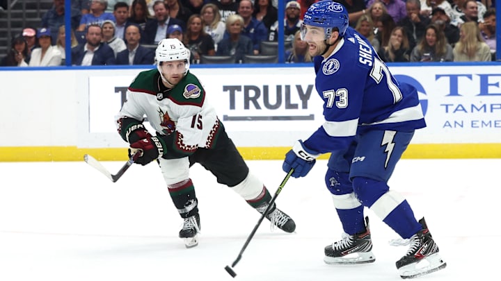 Jan 25, 2024; Tampa, Florida, USA;Tampa Bay Lightning left wing Conor Sheary (73) skates with the puck as Arizona Coyotes center Alexander Kerfoot (15) defends  during the second period at Amalie Arena. Mandatory Credit: Kim Klement Neitzel-USA TODAY Sports
