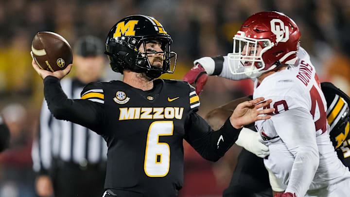 Nov 9, 2024; Columbia, Missouri, USA; Missouri Tigers quarterback Drew Pyne (6) throws a pass against Oklahoma Sooners defensive lineman Ethan Downs (40) during the second half at Faurot Field at Memorial Stadium. 