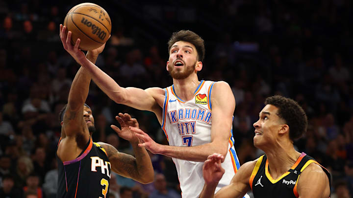 Apr 9, 2025; Phoenix, Arizona, USA; Oklahoma City Thunder forward Chet Holmgren (7) shoots the ball over Phoenix Suns guard Bradley Beal (3) and center Bol Bol (11) during the second half at Footprint Center. Mandatory Credit: Mark J. Rebilas-Imagn Images
