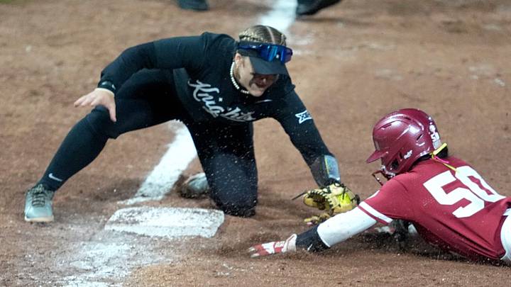 Oklahoma's Ailana Agbayani (50) is tagged out by UCF's Aubrey Evans (3) during the college softball game between the University of Oklahoma Sooners and the UCF Knights at Love's Field in Norman, Okla., Friday, April, 4, 2025.