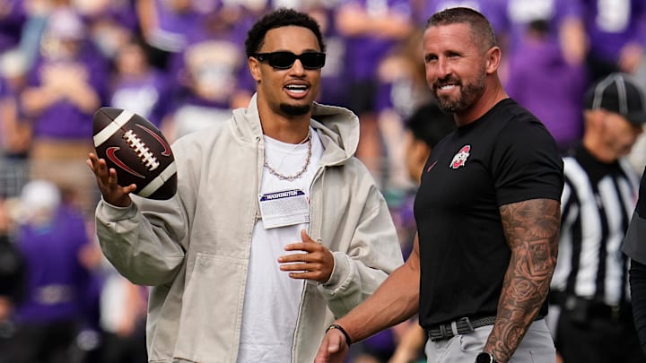 Seattle Seahawks wide receiver Jaxon Smith-Njigba talks to Ohio State Buckeyes offensive coordinator Brian Hartline prior to the NCAA football game against the Washington Huskies at Husky Stadium in Seattle on Sept. 27, 2025.