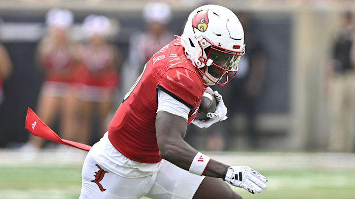 Aug 31, 2024; Louisville, Kentucky, USA;  Louisville Cardinals wide receiver Chris Bell (0) runs the ball against the Austin Peay Governors during the first quarter at L&N Federal Credit Union Stadium. Louisville defeated Austin Peay 62-0. Mandatory Credit: Jamie Rhodes-Imagn Images