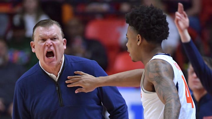 Feb 4, 2024; Champaign, Illinois, USA;  Illinois Fighting Illini guard Justin Harmon (4) holds head